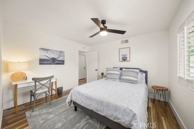 bedroom featuring wood finished floors, baseboards, and ceiling fan
