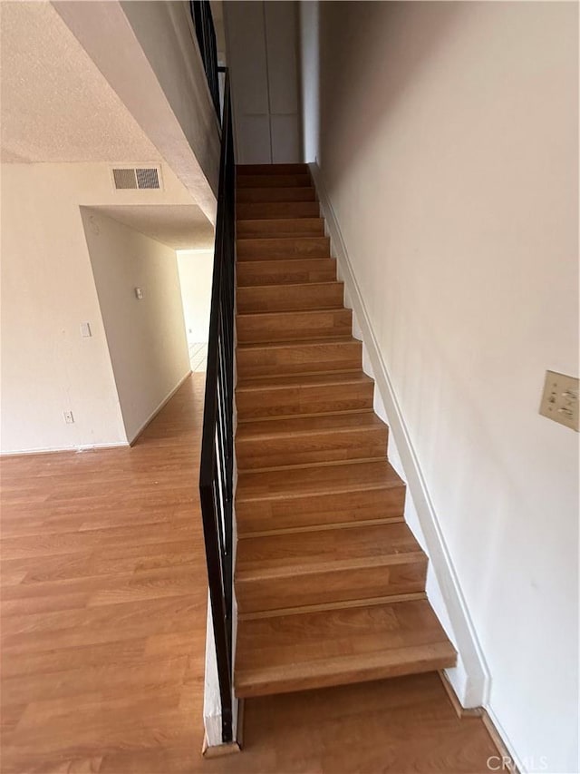 stairs with wood finished floors