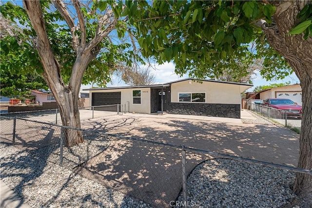 44510 21st St W, Lancaster, CA 93536 - single story home featuring stucco siding, driveway, an attached garage, fence, and stone siding