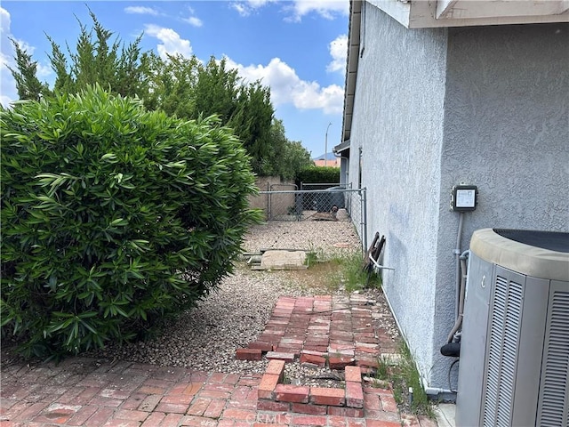 41023 Cedar Ridge Ln, Cherry Valley, CA 92223 - view of side of property featuring stucco siding, fence, and central AC unit