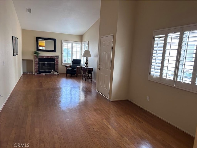 41023 Cedar Ridge Ln, Cherry Valley, CA 92223 - living room featuring dark wood-type flooring, vaulted ceiling, baseboards, and a fireplace
