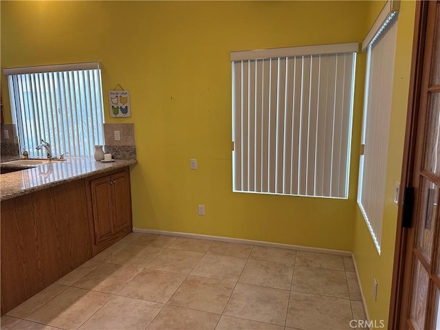 41023 Cedar Ridge Ln, Cherry Valley, CA 92223 - unfurnished dining area featuring a sink, light tile patterned floors, and baseboards
