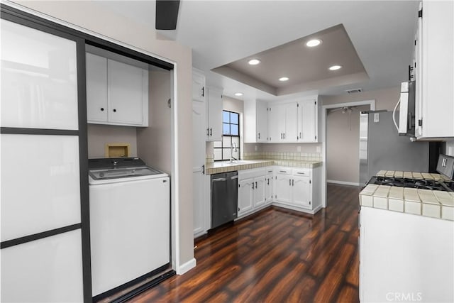201 Lanai Ln, Placentia, CA 92870 - kitchen with stainless steel appliances, washer / dryer, dark wood-type flooring, a tray ceiling, and white cabinets