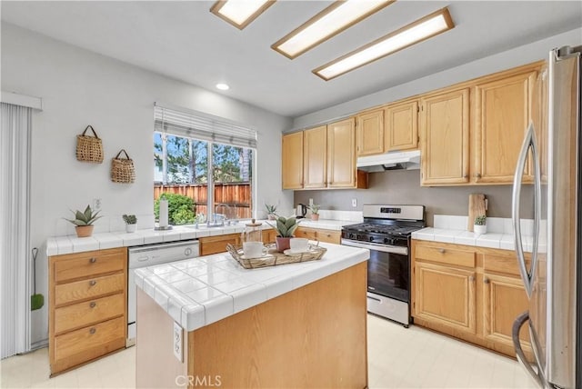 6981 Rivertrails Dr, Eastvale, CA 91752 - kitchen with stainless steel appliances, under cabinet range hood, light flooring, a center island, and tile counters