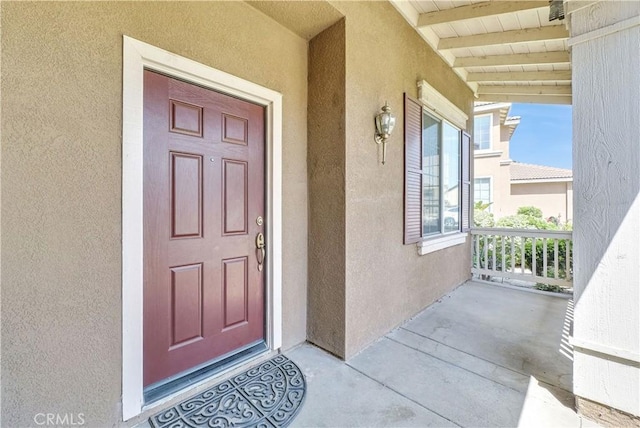 6981 Rivertrails Dr, Eastvale, CA 91752 - view of exterior entry featuring stucco siding and covered porch