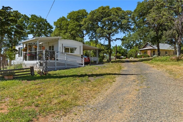 2831 Foothill Blvd, Oroville, CA 95966 - view of front of home with gravel driveway, covered porch, and an attached carport