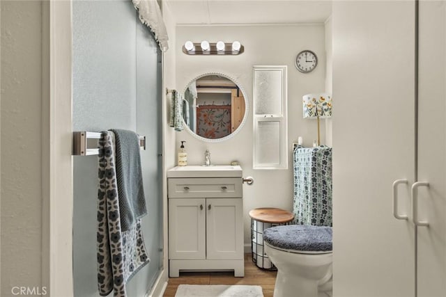 2831 Foothill Blvd, Oroville, CA 95966 - bathroom featuring wood finished floors, vanity, and toilet