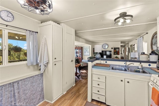 2831 Foothill Blvd, Oroville, CA 95966 - kitchen featuring a sink, light wood-style floors, and white cabinets
