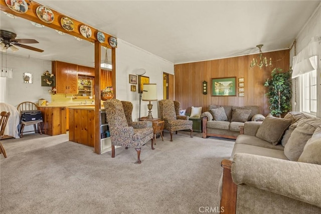 2831 Foothill Blvd, Oroville, CA 95966 - living room with light carpet, wood walls, ceiling fan, a chandelier, and crown molding