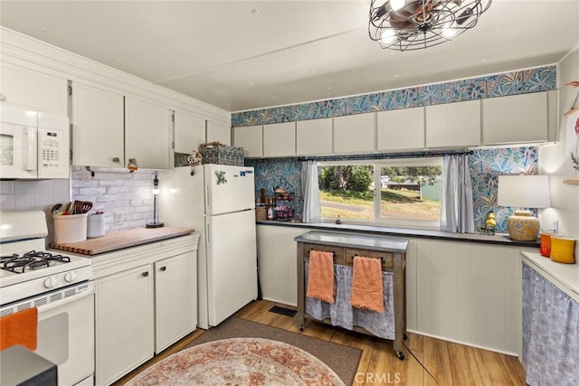2831 Foothill Blvd, Oroville, CA 95966 - kitchen featuring white appliances, light wood-style floors, tasteful backsplash, and white cabinets
