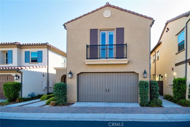 223 Gaspar, Irvine, CA 92618 - mediterranean / spanish home featuring a balcony, stucco siding, a garage, and a tiled roof
