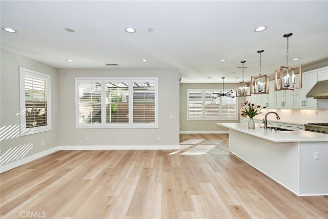 223 Gaspar, Irvine, CA 92618 - kitchen with light countertops, recessed lighting, baseboards, light wood-style floors, and hanging light fixtures