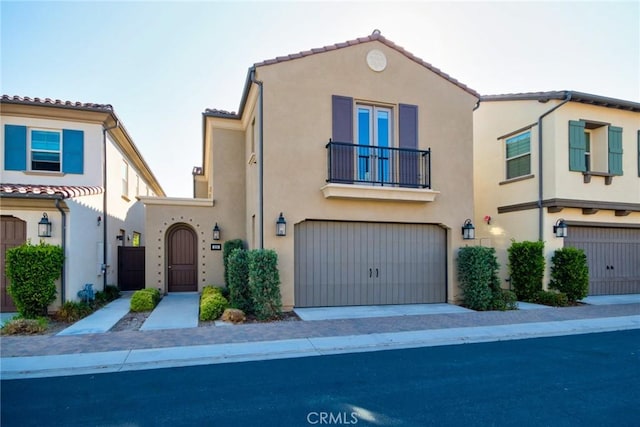 223 Gaspar, Irvine, CA 92618 - view of front of home featuring a balcony, stucco siding, and a garage