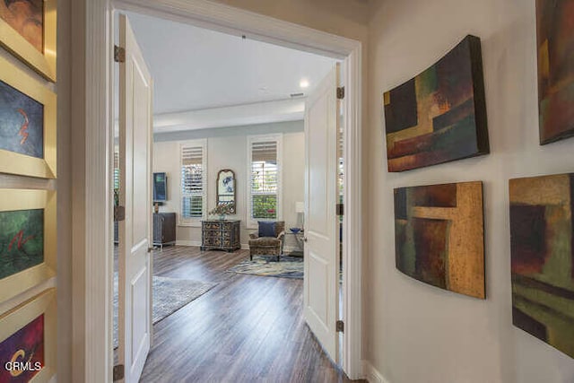 hall featuring wood finished floors and baseboards