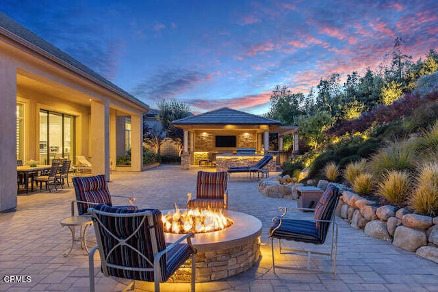 view of patio / terrace with a fire pit and a gazebo