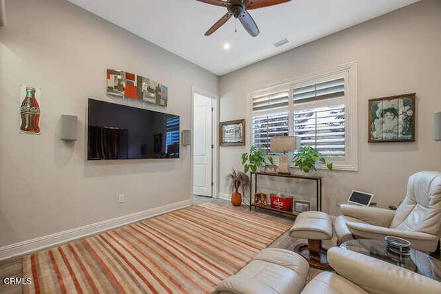 living area featuring ceiling fan, baseboards, and recessed lighting