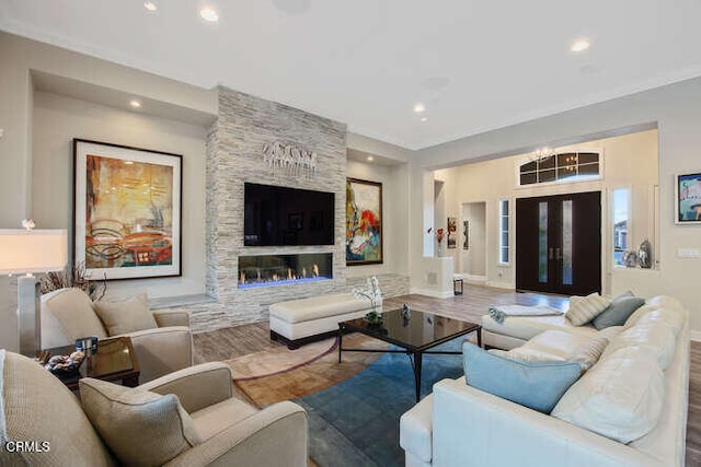 living room with wood finished floors, recessed lighting, and baseboards