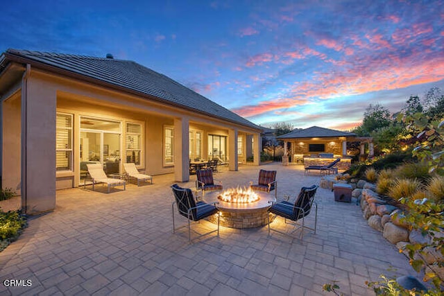 view of patio / terrace with an outdoor fire pit and a gazebo