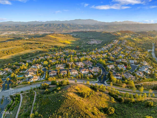 aerial overview of property's location with mountains and nearby suburban area