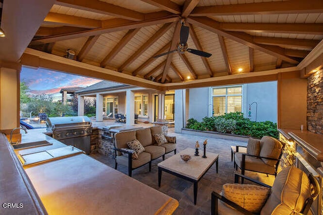 view of patio with an outdoor kitchen, a gazebo, an outdoor living space, grilling area, and a sink