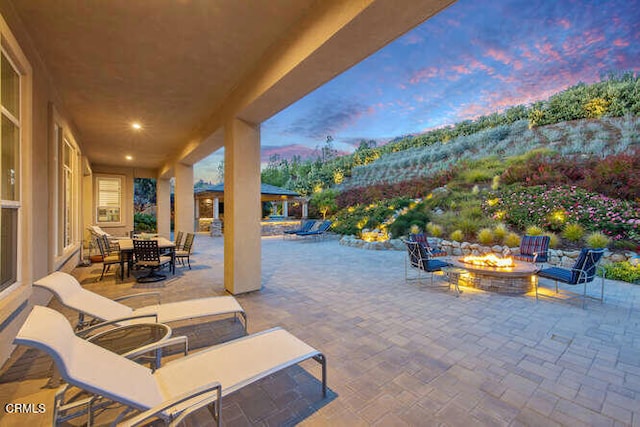 patio terrace at dusk with an outdoor fire pit