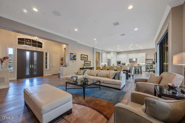 living area featuring ornamental molding, recessed lighting, and wood finished floors