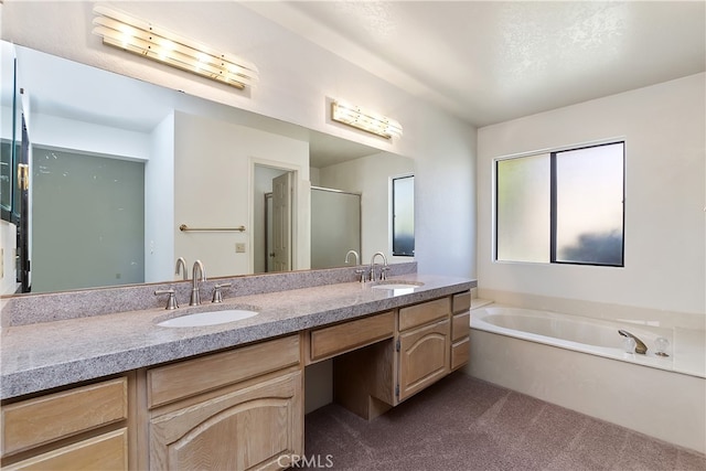 bathroom with double vanity, a garden tub, and a shower with shower door