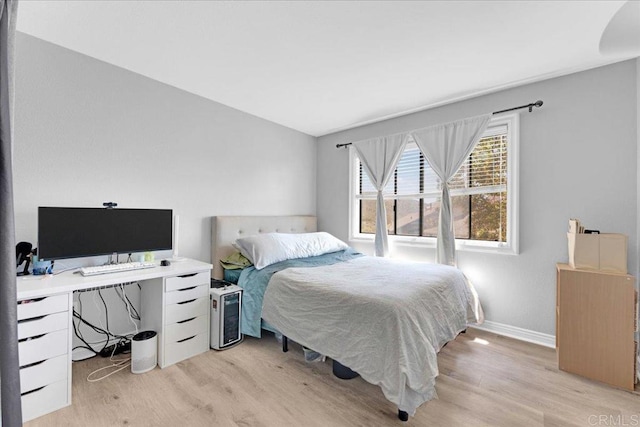 bedroom featuring light wood-type flooring and baseboards