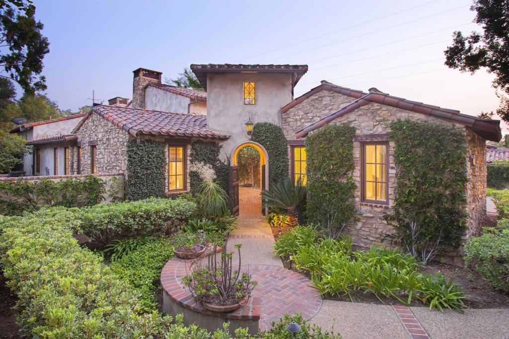 7031 Calle Portone, Rancho Santa Fe, CA 92091 - mediterranean / spanish house featuring stone siding, a chimney, stucco siding, and a tile roof