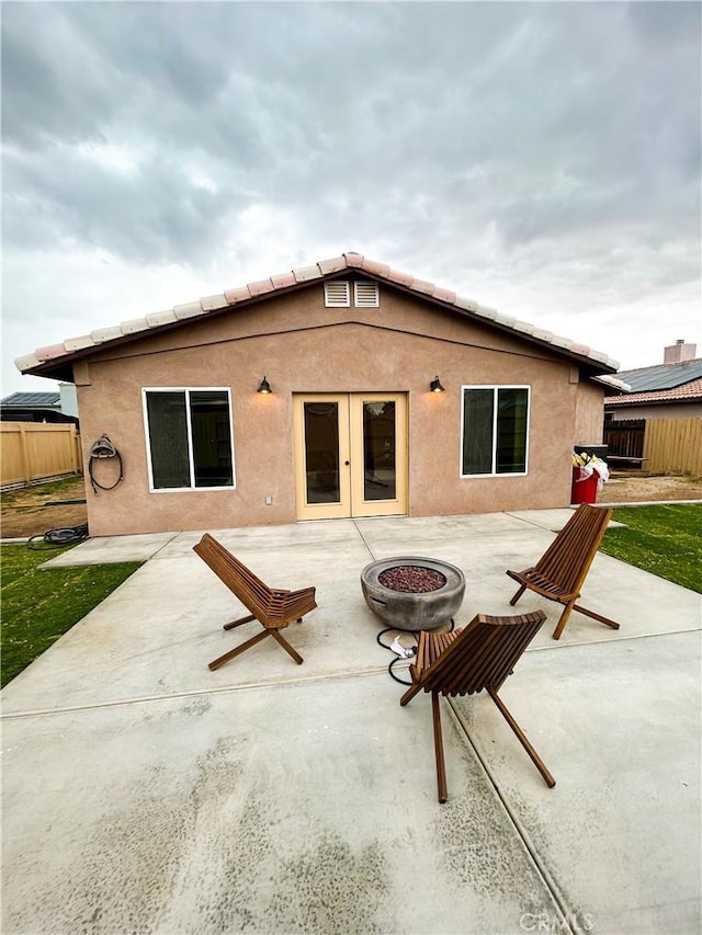 770 Cypress Ln, Blythe, CA 92225 - back of house with an outdoor fire pit, fence, a patio area, and stucco siding