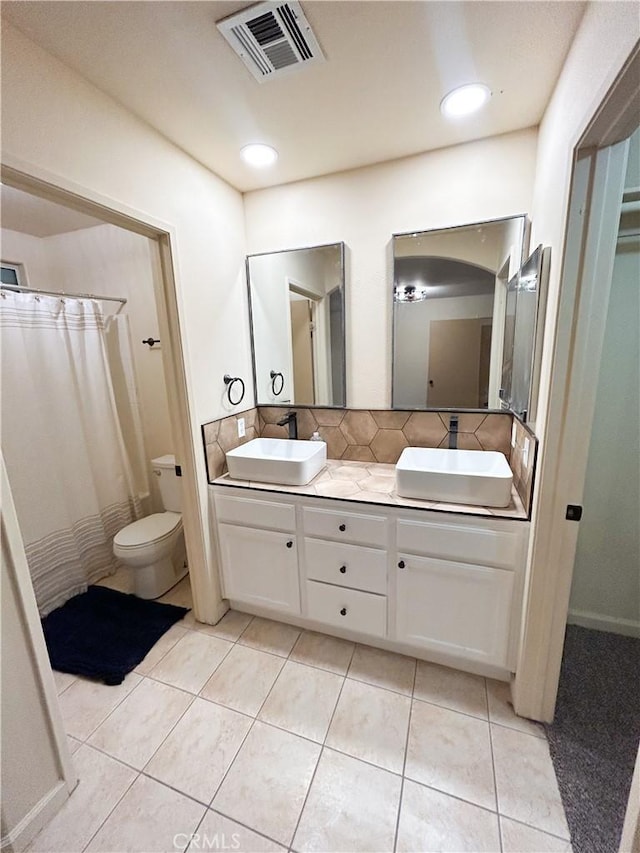 770 Cypress Ln, Blythe, CA 92225 - bathroom featuring double vanity, toilet, tile patterned floors, and backsplash