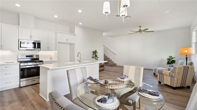 362 S Halcyon Rd, Arroyo Grande, CA 93420 - dining room featuring stairs, light wood-type flooring, recessed lighting, a chandelier, and ceiling fan