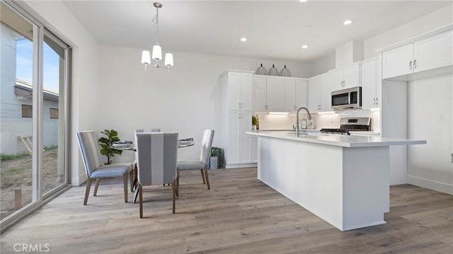 362 S Halcyon Rd, Arroyo Grande, CA 93420 - kitchen with appliances with stainless steel finishes, a chandelier, decorative backsplash, white cabinets, and recessed lighting