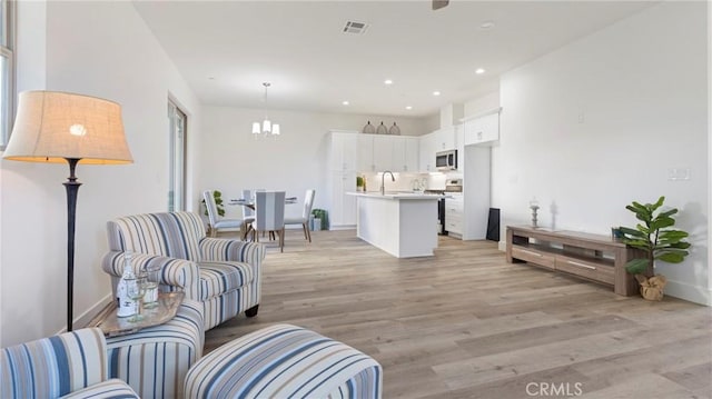 362 S Halcyon Rd, Arroyo Grande, CA 93420 - living room with light wood-style flooring, a chandelier, recessed lighting, and baseboards