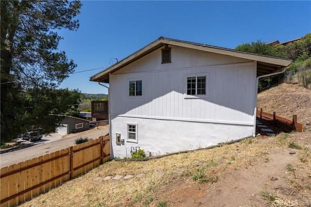 view of side of home with fence