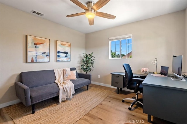 office with baseboards, light wood-style floors, and a ceiling fan
