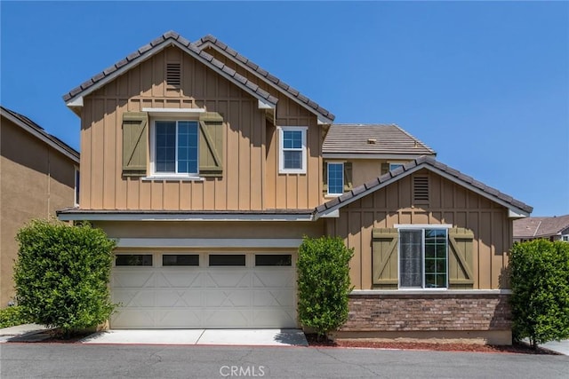 22069 Windham Way, Saugus, CA 91350 - craftsman-style house with board and batten siding, a tile roof, an attached garage, and driveway