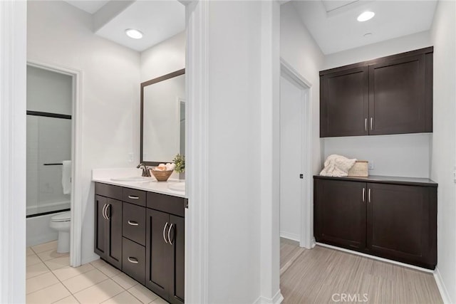 22069 Windham Way, Saugus, CA 91350 - full bath with double vanity, toilet, baseboards, and shower / tub combination