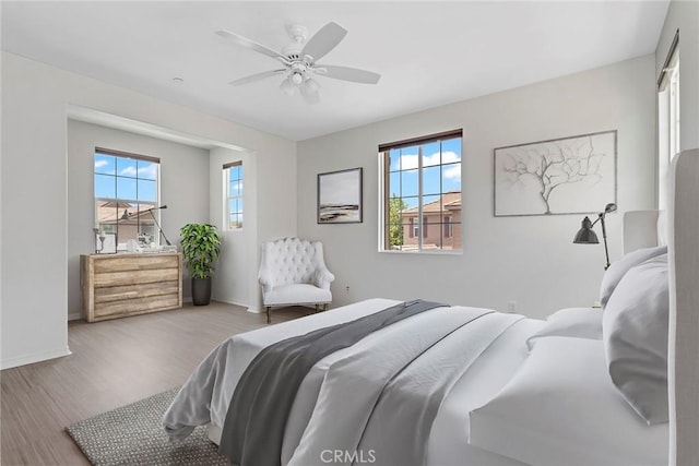 22069 Windham Way, Saugus, CA 91350 - bedroom featuring wood finished floors, multiple windows, baseboards, and a ceiling fan