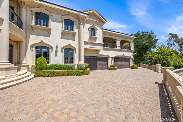 328 N Terrace View Dr, Monrovia, CA 91016 - view of front of property with a garage, a balcony, decorative driveway, and stucco siding