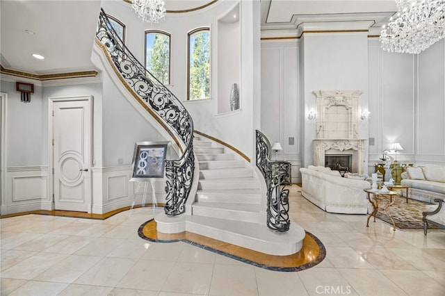 328 N Terrace View Dr, Monrovia, CA 91016 - staircase with a decorative wall, a chandelier, crown molding, a premium fireplace, and recessed lighting