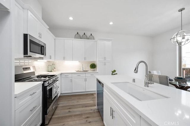 360 S Halcyon Rd, Arroyo Grande, CA 93420 - kitchen featuring stainless steel appliances, white cabinetry, recessed lighting, backsplash, and light wood-type flooring