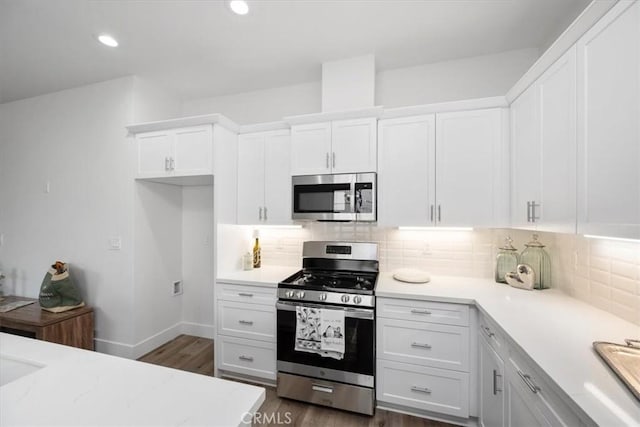 360 S Halcyon Rd, Arroyo Grande, CA 93420 - kitchen with appliances with stainless steel finishes, white cabinetry, dark wood-style flooring, decorative backsplash, and recessed lighting