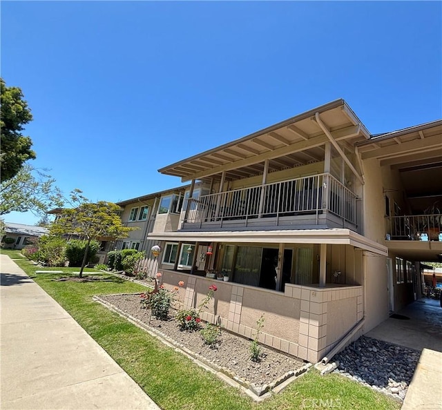 back of property featuring a balcony