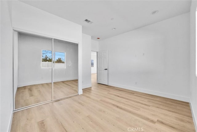 16938 Bell Ave, Lake Elsinore, CA 92530 - unfurnished bedroom with wood finished floors, baseboards, and a closet