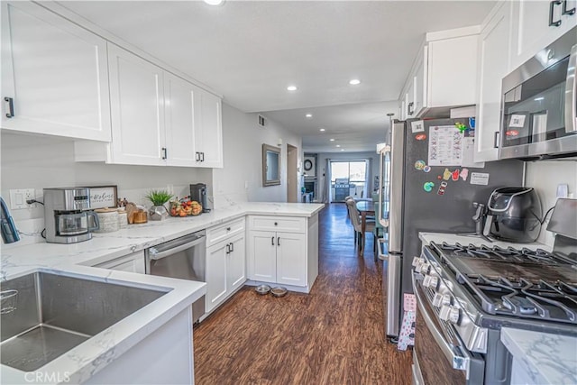 18111 Erik Ct Unit 445, Canyon Country, CA 91387 - kitchen featuring stainless steel appliances, dark wood finished floors, recessed lighting, white cabinets, and a peninsula