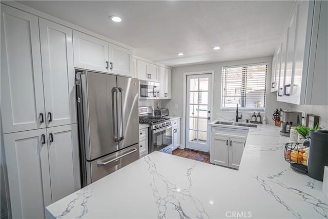 18111 Erik Ct Unit 445, Canyon Country, CA 91387 - kitchen featuring appliances with stainless steel finishes, a sink, recessed lighting, white cabinetry, and light stone countertops