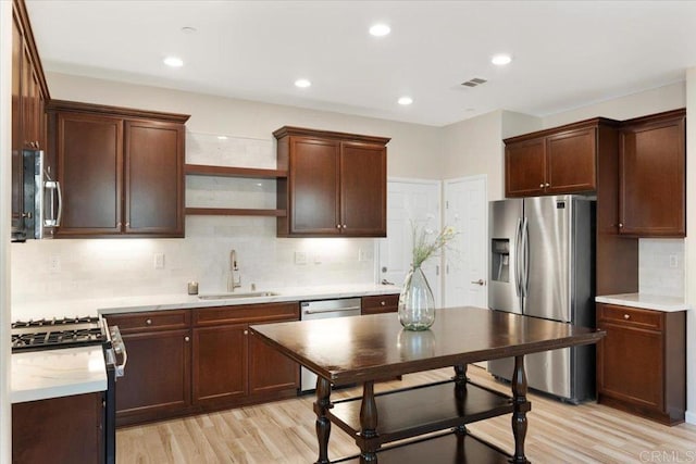 1514 Crown Ln Unit 1, Chula Vista, CA 91915 - kitchen featuring appliances with stainless steel finishes, light wood finished floors, light countertops, decorative backsplash, and recessed lighting