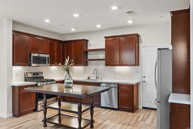 1514 Crown Ln Unit 1, Chula Vista, CA 91915 - kitchen with stainless steel appliances, light wood-type flooring, decorative backsplash, light countertops, and recessed lighting
