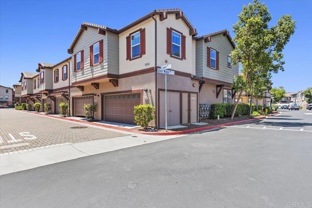 1514 Crown Ln Unit 1, Chula Vista, CA 91915 - view of front of home with a garage, a residential view, and stucco siding